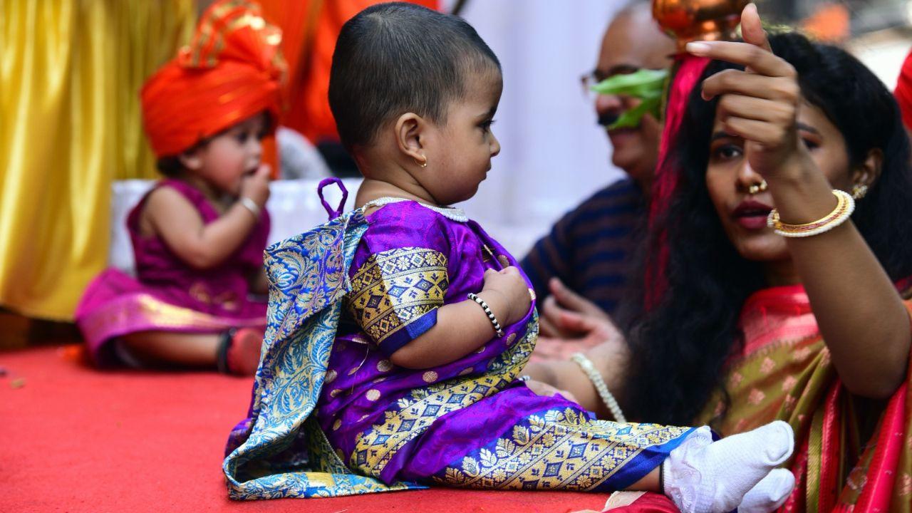 A little munchkin belonging to the new generation sits dressed up in a violet-coloured saree with gold and blue designs as she learns about the richness of her culture and festival from early on. (Mid-day Photo/Shadab Khan) 